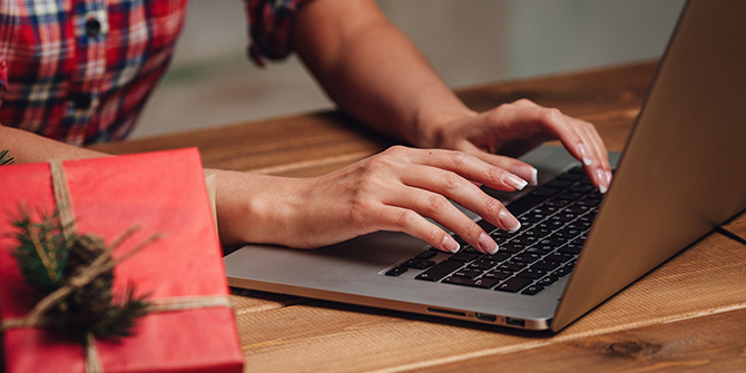 Present on table, hands typing on laptop