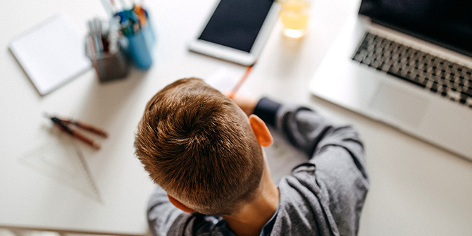 Boy sitting at a table doing homework