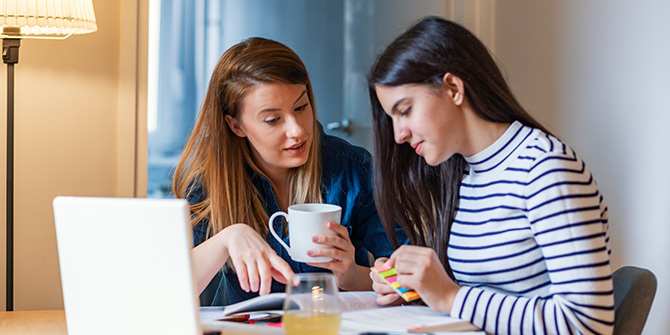 Woman talking to her teen daughter about finances