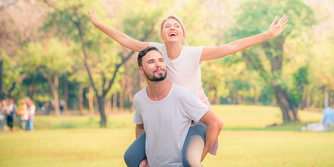 Young couple in a park looking excited