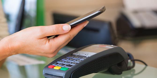 Woman using smart phone to make a purchase