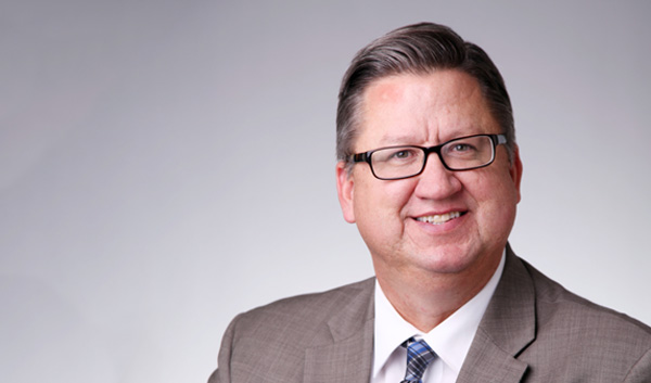 Headshot of President & CEO, Dwayne Naylor 