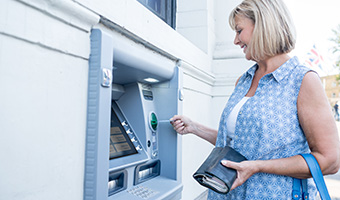 Woman withdrawing cash from an ATM.