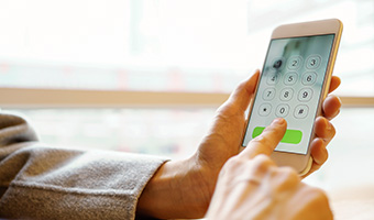 Photo of female hands using a smartphone.