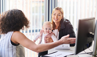 Young mother sits with her daughter in an advisor's office.