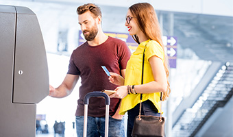 Couple withdrawing money at the airport