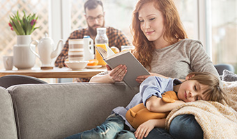 A peaceful family with a young son relaxing at home. 