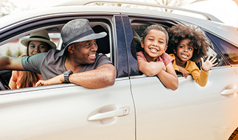 Young family taking a road trip in their car. 