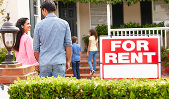 Smiling family outside rental home.