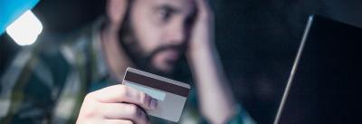 Worried man holding credit card