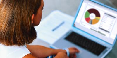 Woman using a laptop to make money plans