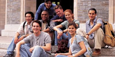 college students sitting together on steps of building