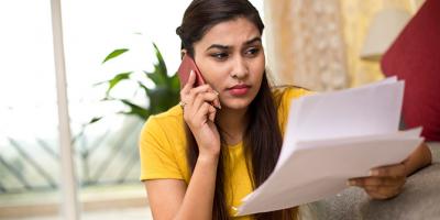 Woman on phone looking at papers