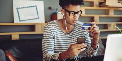 Young man shopping online with a credit card
