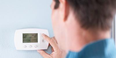 Man checking thermostat