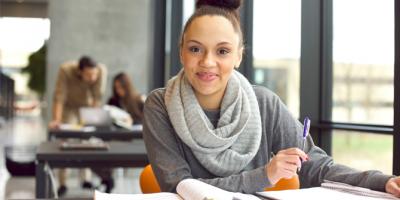 Young woman holding a pen