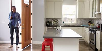 Man opening door of apartment