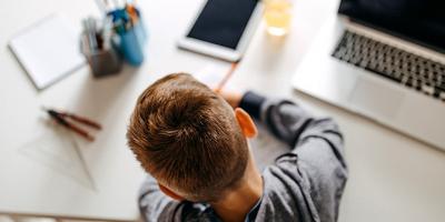 Boy sitting at a table doing homework