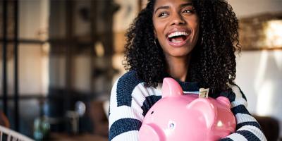 Woman hugging her piggy bank