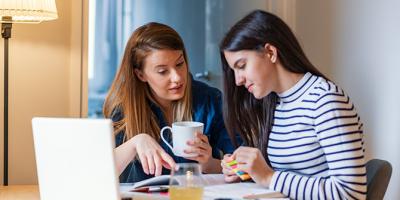 Woman talking to her teen daughter about finances