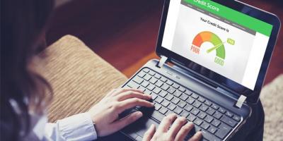 Woman checking her credit score on a laptop