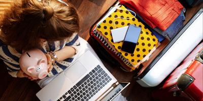 Woman holding piggy bank planning a trip