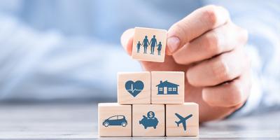 Wooden blocks with icons representing insurance types