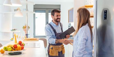 Woman shaking hands with plumber