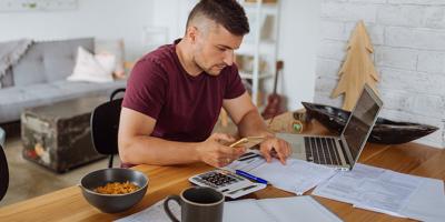 Young man checking bill statements