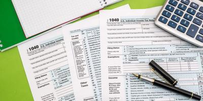 Tax forms, calculator, pen
