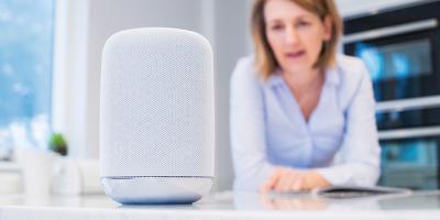 Woman looking at a smart speaker