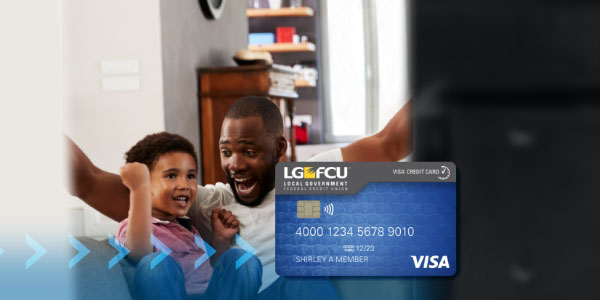 Father and young son cheering with LGFCU Debit Card in foreground