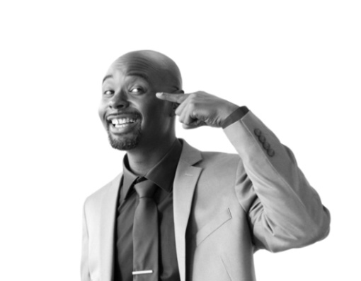 Man smiles and points to his eyes.