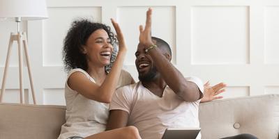 Excited couple give high five celebrating success