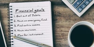 Financial goals written on note pad