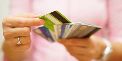 Female hand choosing between retail and credit cards