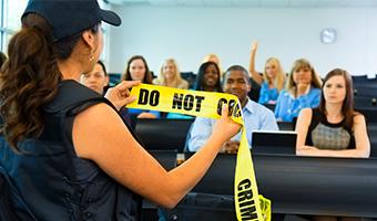 Uniformed policewoman addresses an audience.