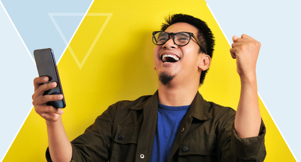 Man celebrating and holding smart phone
